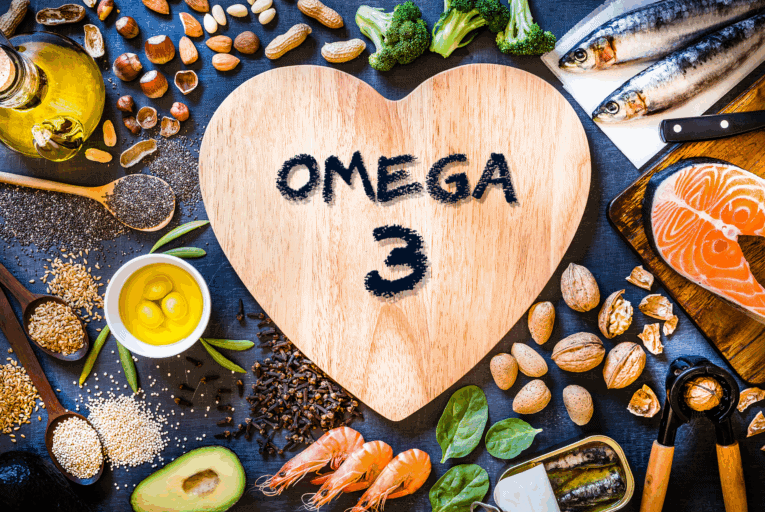 a heart shaped wooden board surrounded by food