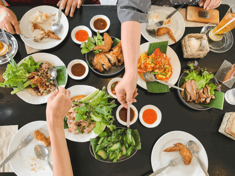 a group of people eating food at a table
