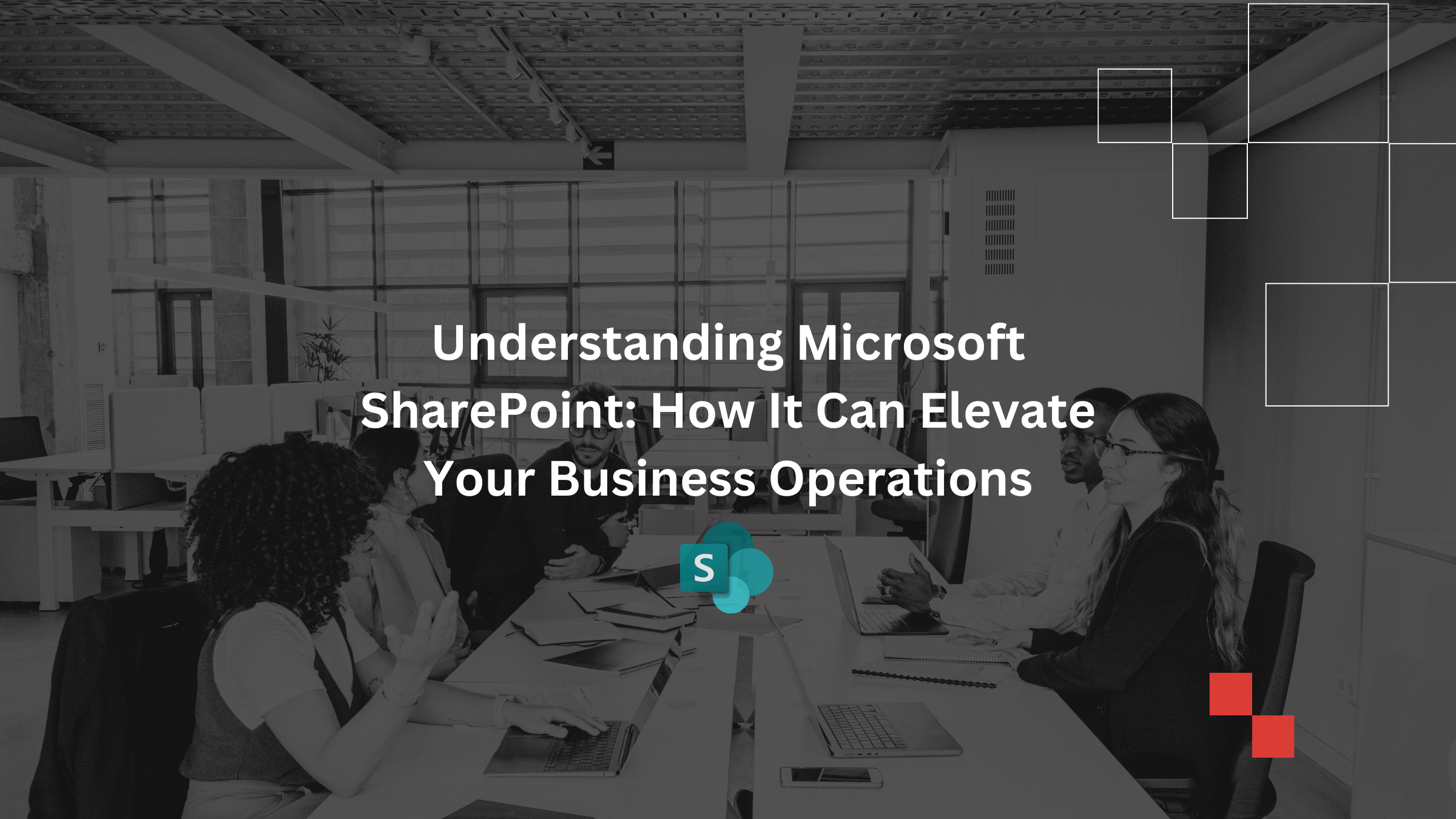 Business professionals collaborating around a table with laptops and documents in a modern office, illustrating teamwork and digital collaboration using SharePoint.