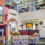 Spanish style lounge with upper eating area at Ivy Park Senior Living in Culver City, CA