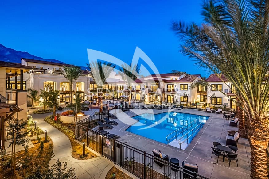 Beautiful night time shot of Merrill Gardens Rancho Cucamonga's outdoor area and pool