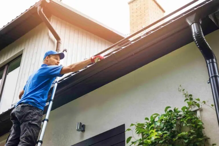 Professional gutter cleaning on residential property in Manchester.