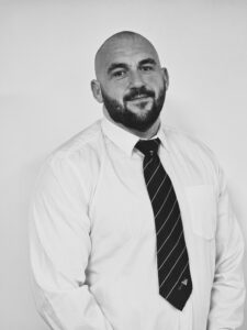Professional team member from Servicemaster Manchester in formal attire.
