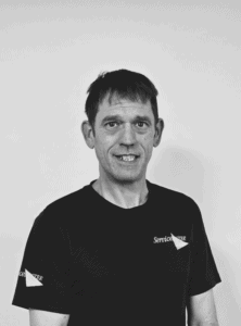 Professional team member from Servicemaster Manchester smiling in uniform.