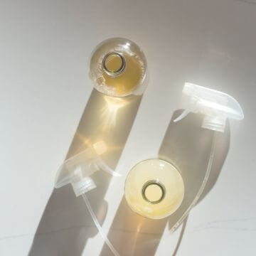 glass bottles with toxic free cleaner in sunshine