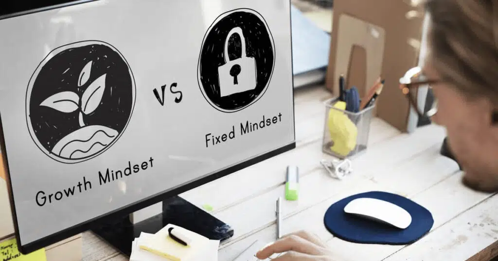 man looking at computer screen with growth mindset vs. fixed mindset