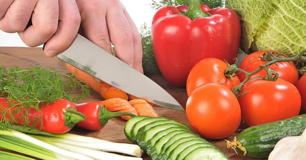 woman cutting fruits and vegetables