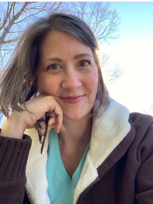 Tina, "she welcomes wellness" outside on a sunny day