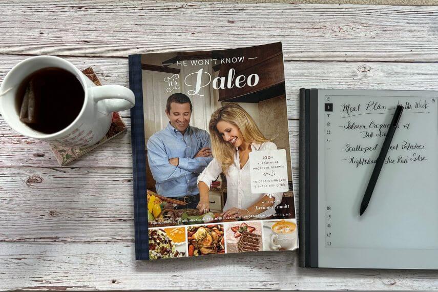 He Won't Know It's Paleo cookbook, digital notebook, digital pencil, and cup of tea