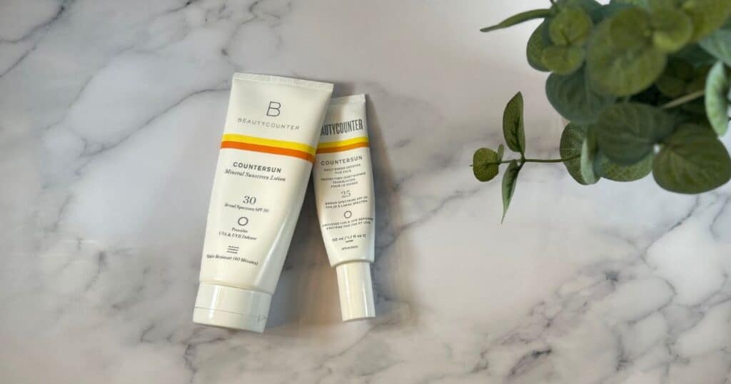 Beautycounter sunscreen and Daily Defense sunscreen on counter
