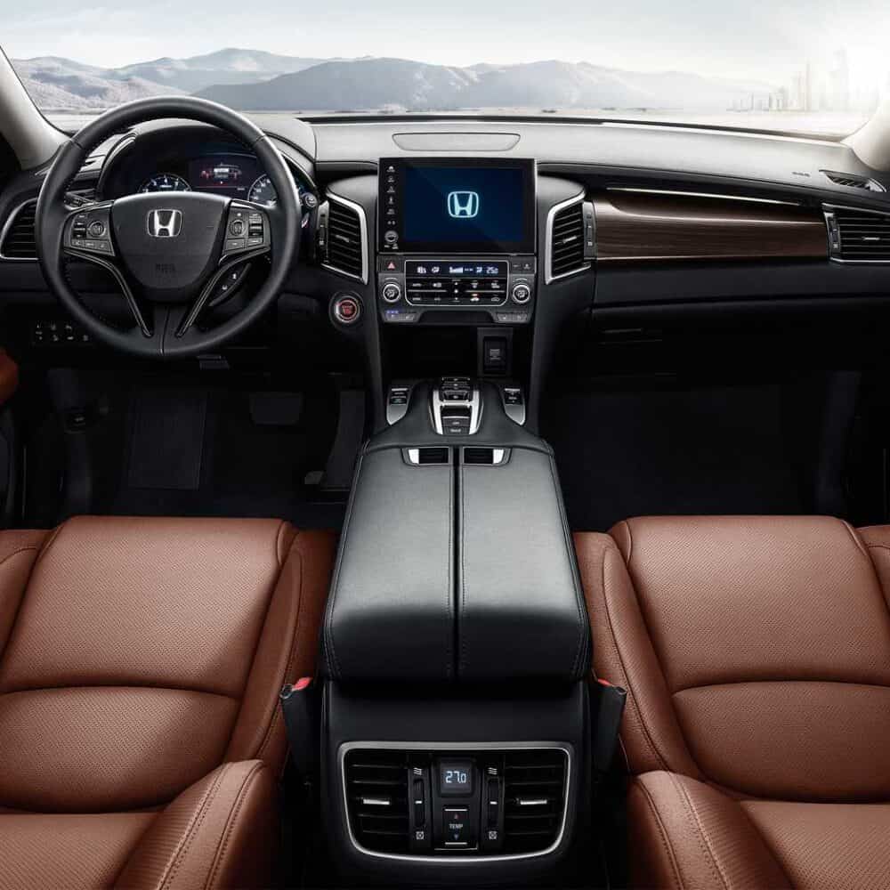 Interior dashboard and steering wheel of Honda Avancier with custom accessories.