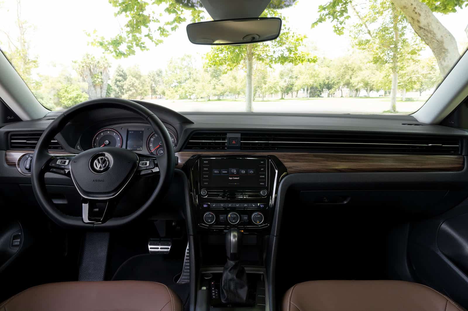 Volkswagen Passat 2019 interior dashboard and steering wheel with wood trim accents.