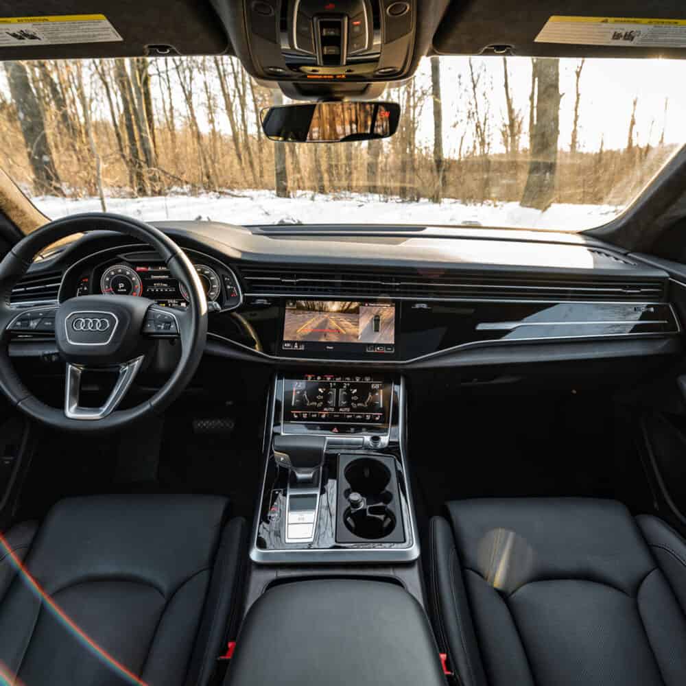 Audi Q8 interior dashboard and steering wheel with modern design and high-quality materials.