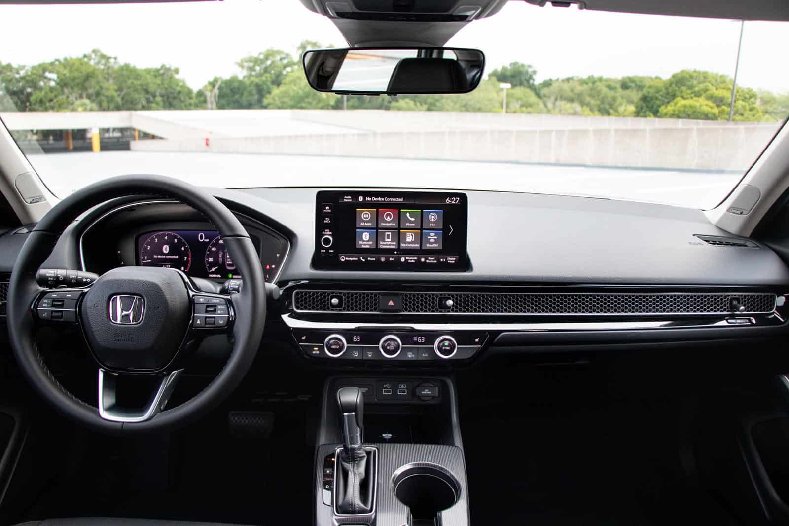 Interior dashboard of Honda Civic with touchscreen infotainment and sleek design.
