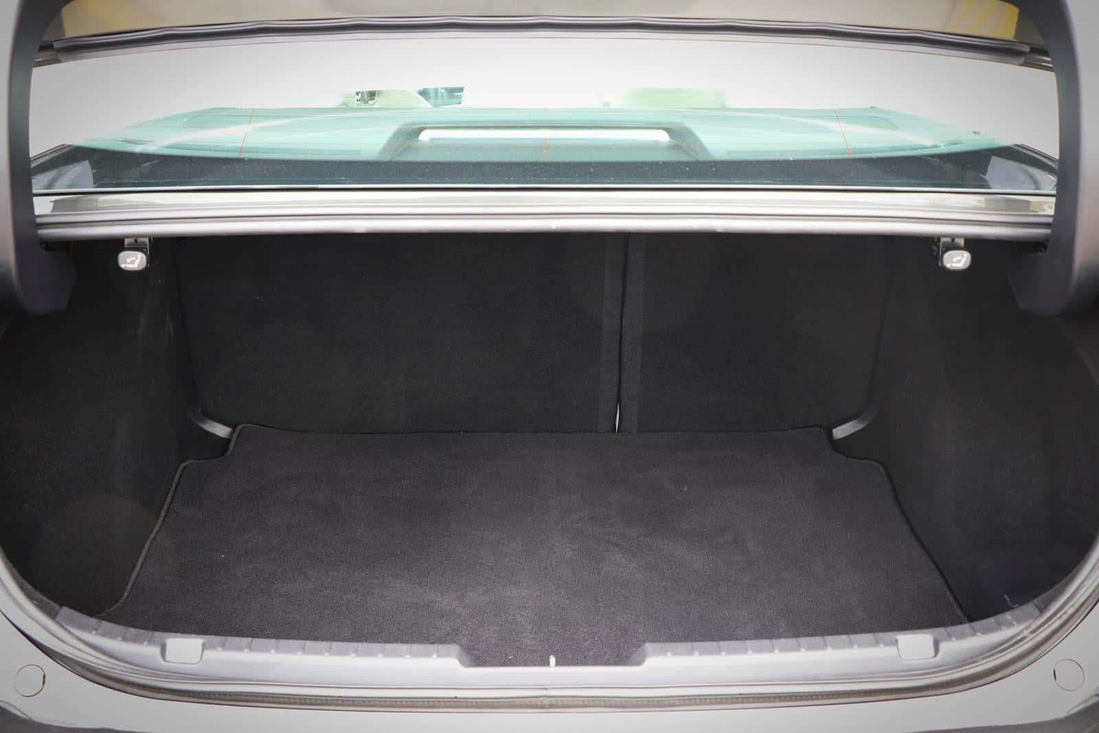 Mazda 3 trunk cargo area with protective lining and accessories.