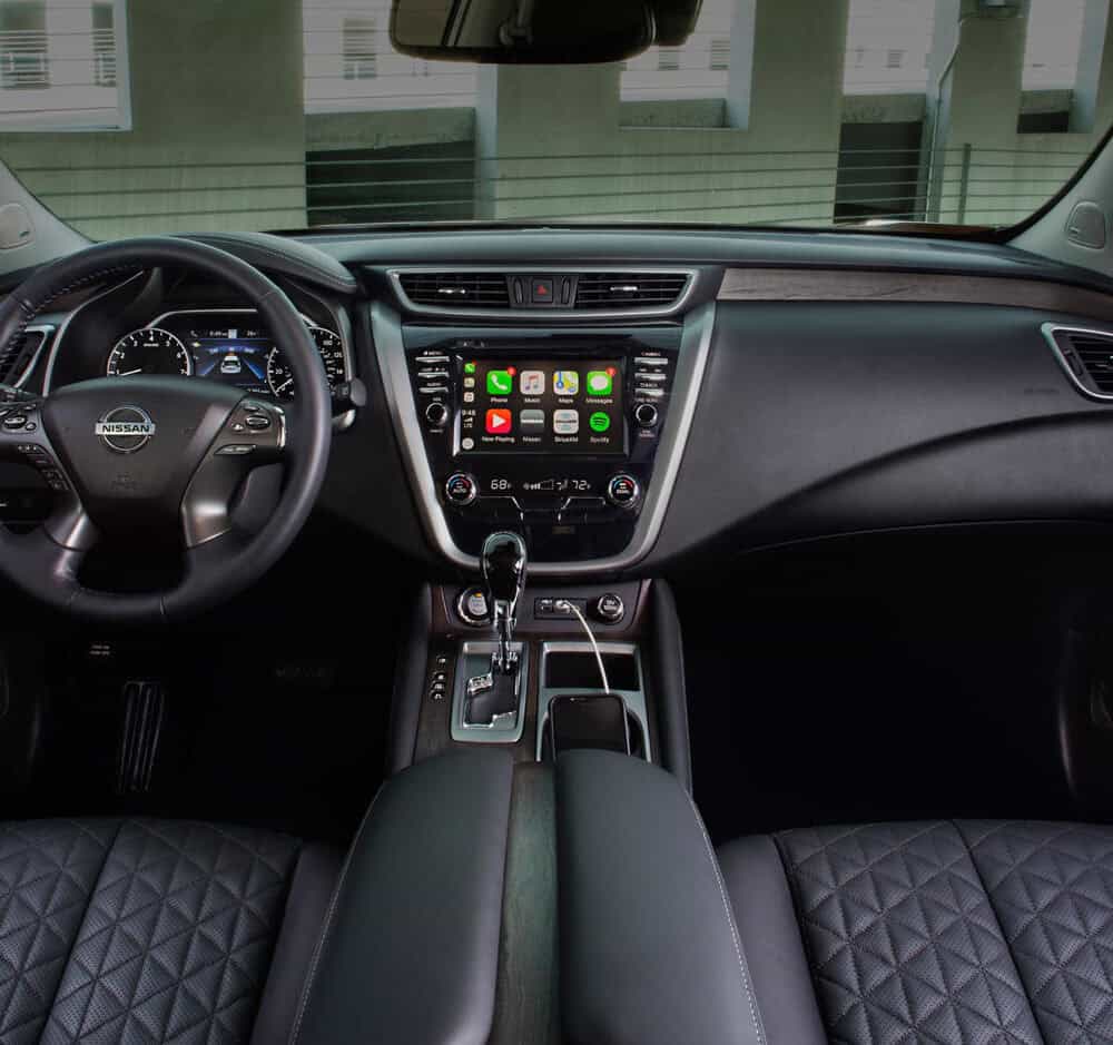 Interior dashboard and steering wheel of Nissan Murano with custom accessories.