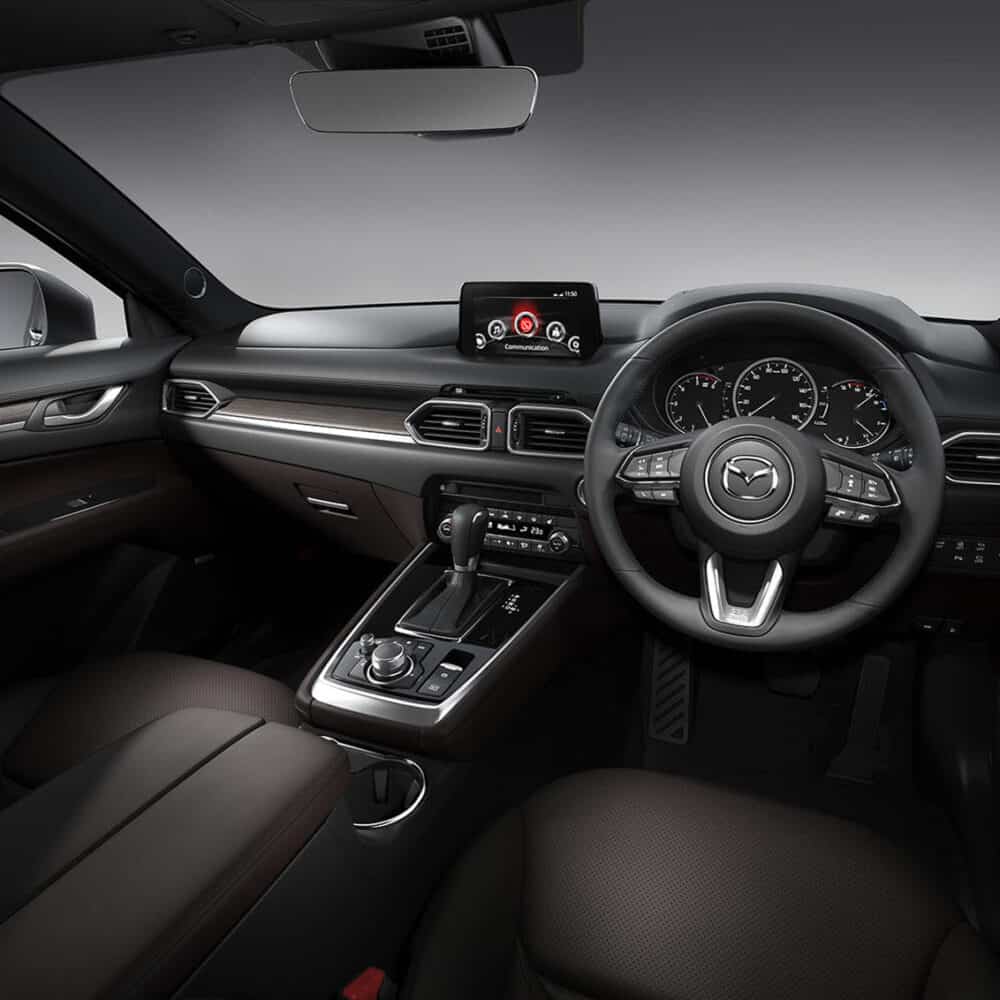 Interior dashboard and steering wheel of Mazda CX-8 with custom accessories.
