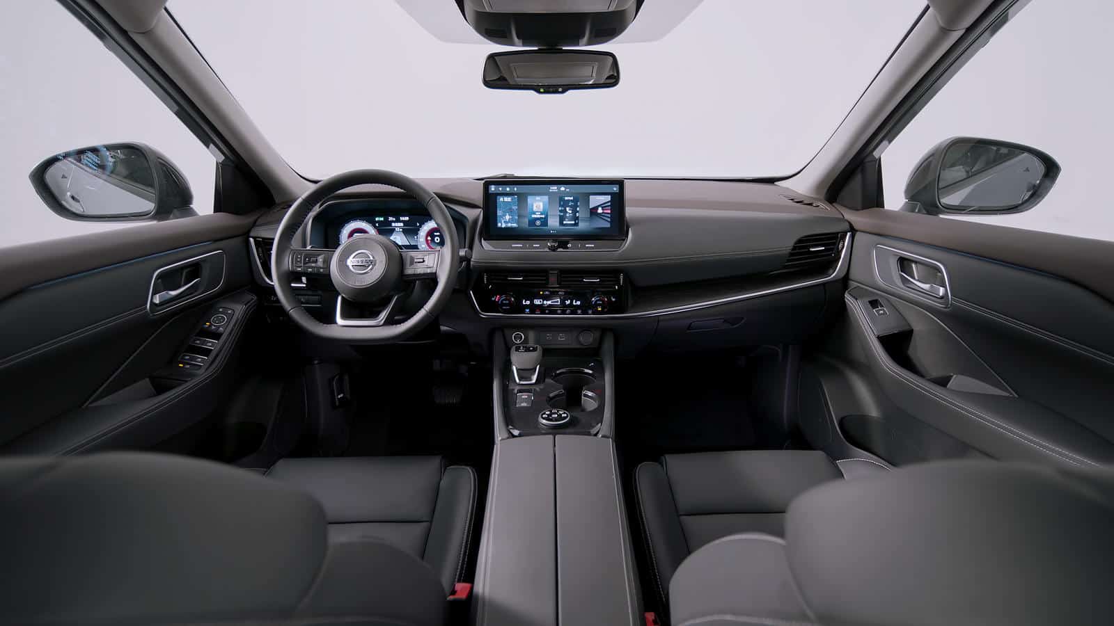 Interior dashboard and steering wheel of Nissan X-Trail with custom accessories.