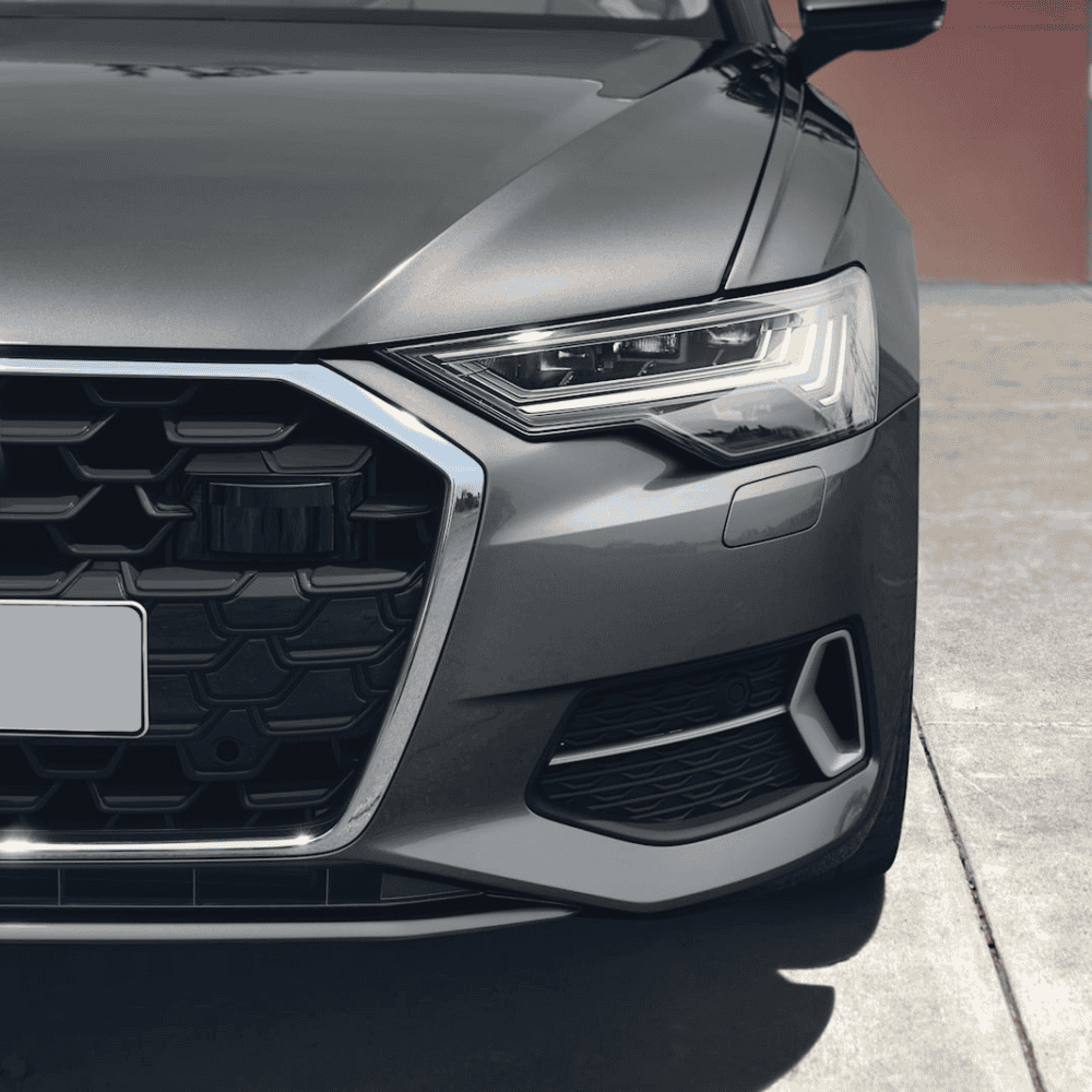 Close-up of Audi A6 headlamp with modern LED lighting and sleek design.