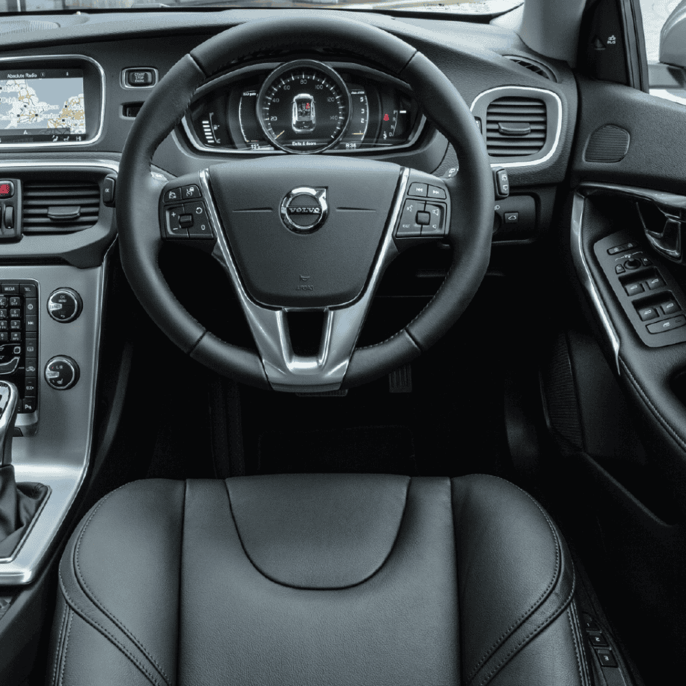 Interior dashboard and steering wheel of Volvo V40 2013-2019 with custom accessories.
