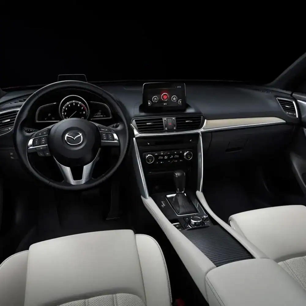 Interior dashboard and steering wheel of Mazda CX-4 with custom accessories.