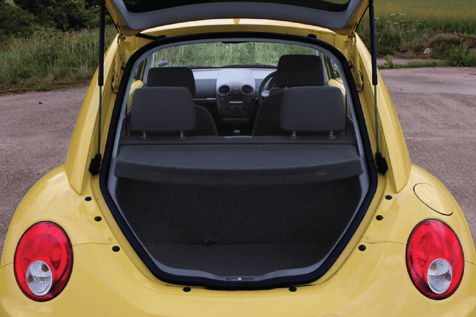 Volkswagen Beetle trunk organizer for luggage and cargo storage.