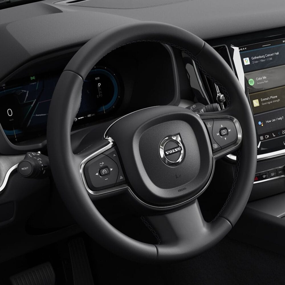 Interior dashboard with Volvo S60 touchscreen display and steering wheel.