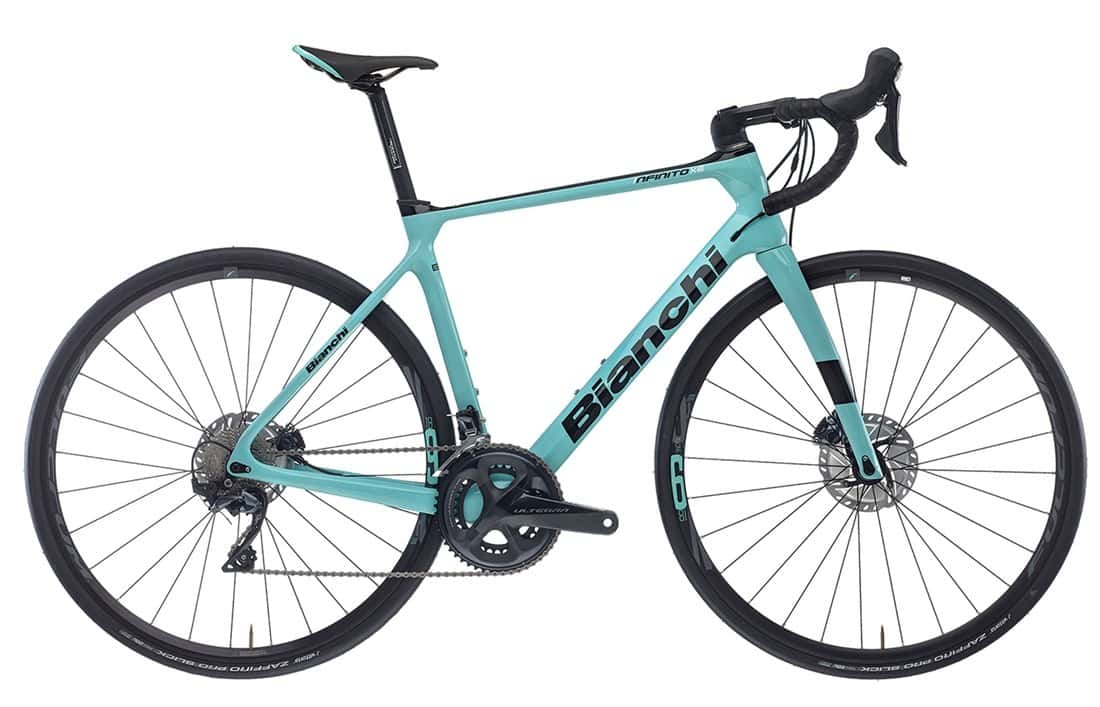 Light blue Bianchi road bike with carbon frame and drop handlebars for road cycling.