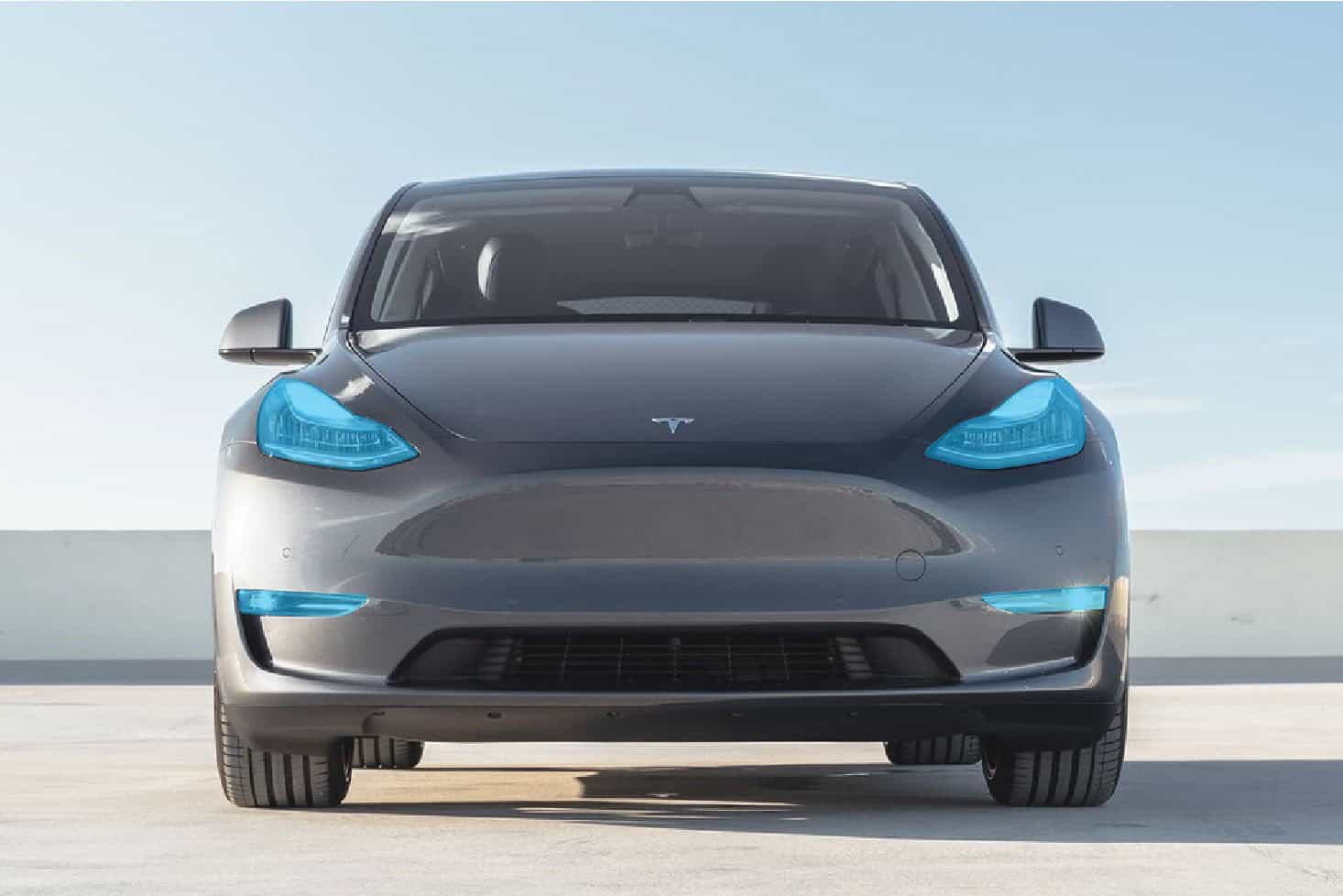 Modern Tesla Model 3 electric vehicle on a clear day.