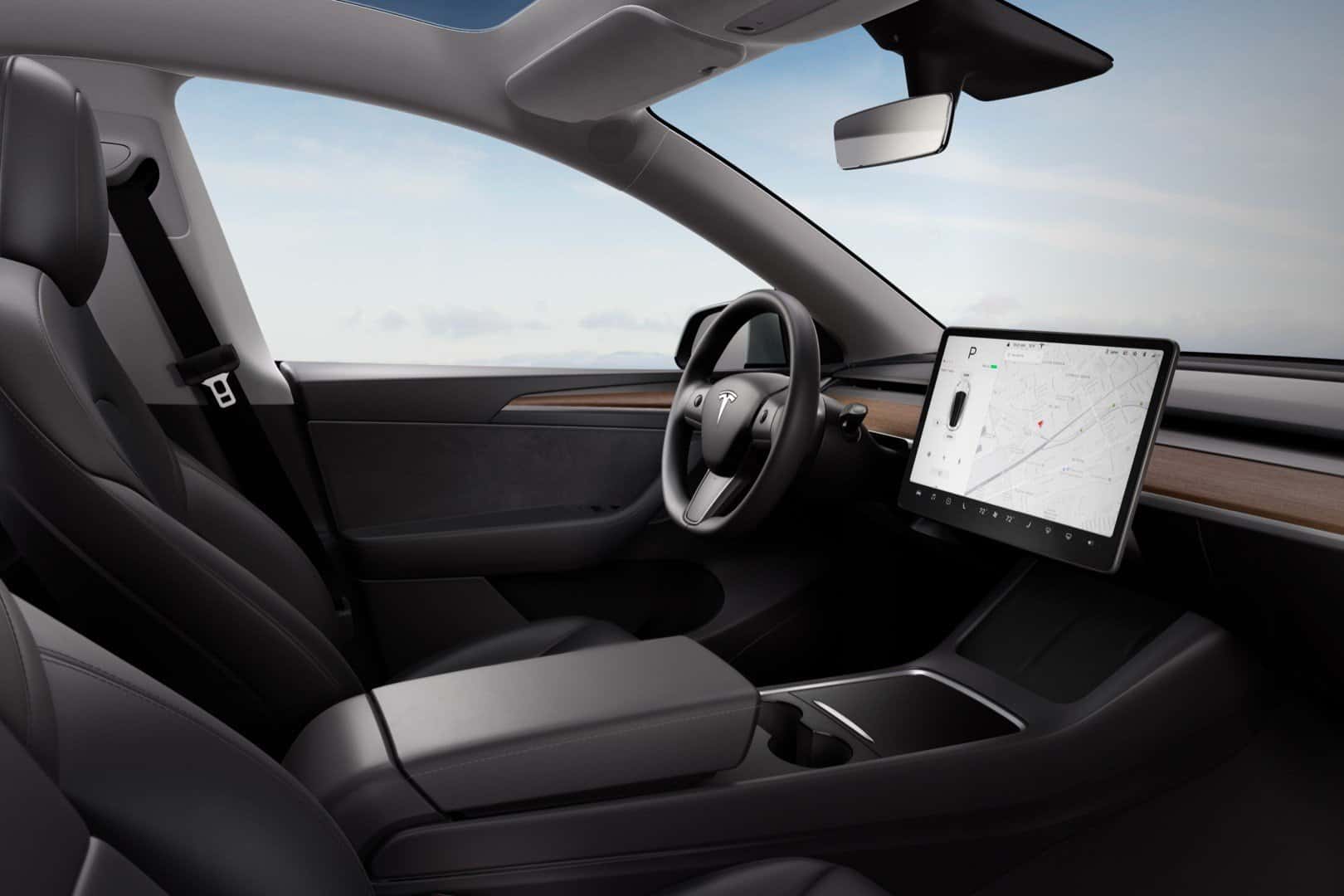 Tesla Model 3 interior showcasing a sleek dashboard and advanced touchscreen control system.