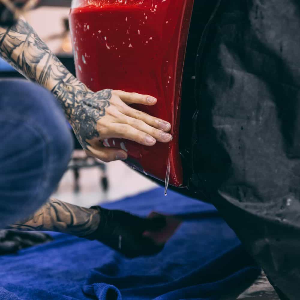 High-quality PPF film applied to car side fender and bumper for protection.