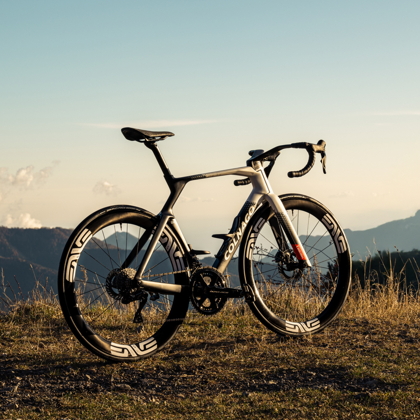 High-performance Colnago Y1RS road bike on scenic mountain background.