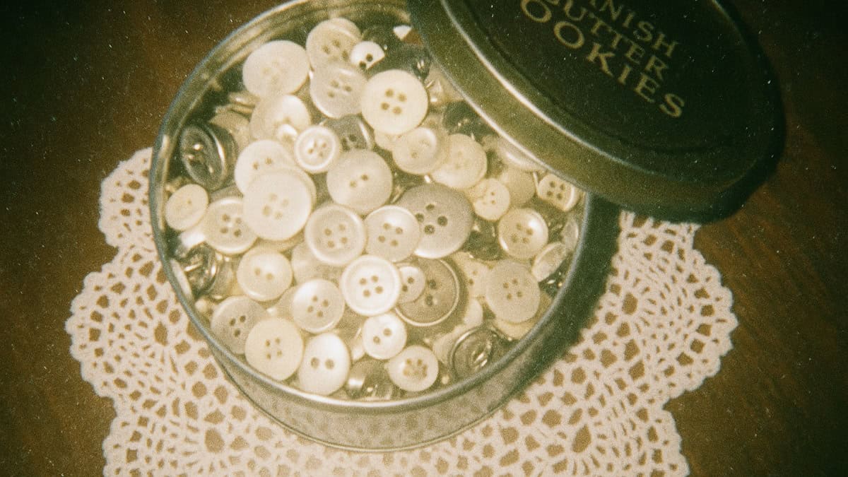 Forgotten Household Items Our Grandparents Swore By 13 A vintage button tin filled with assorted buttons, representing a cherished grandma's item.