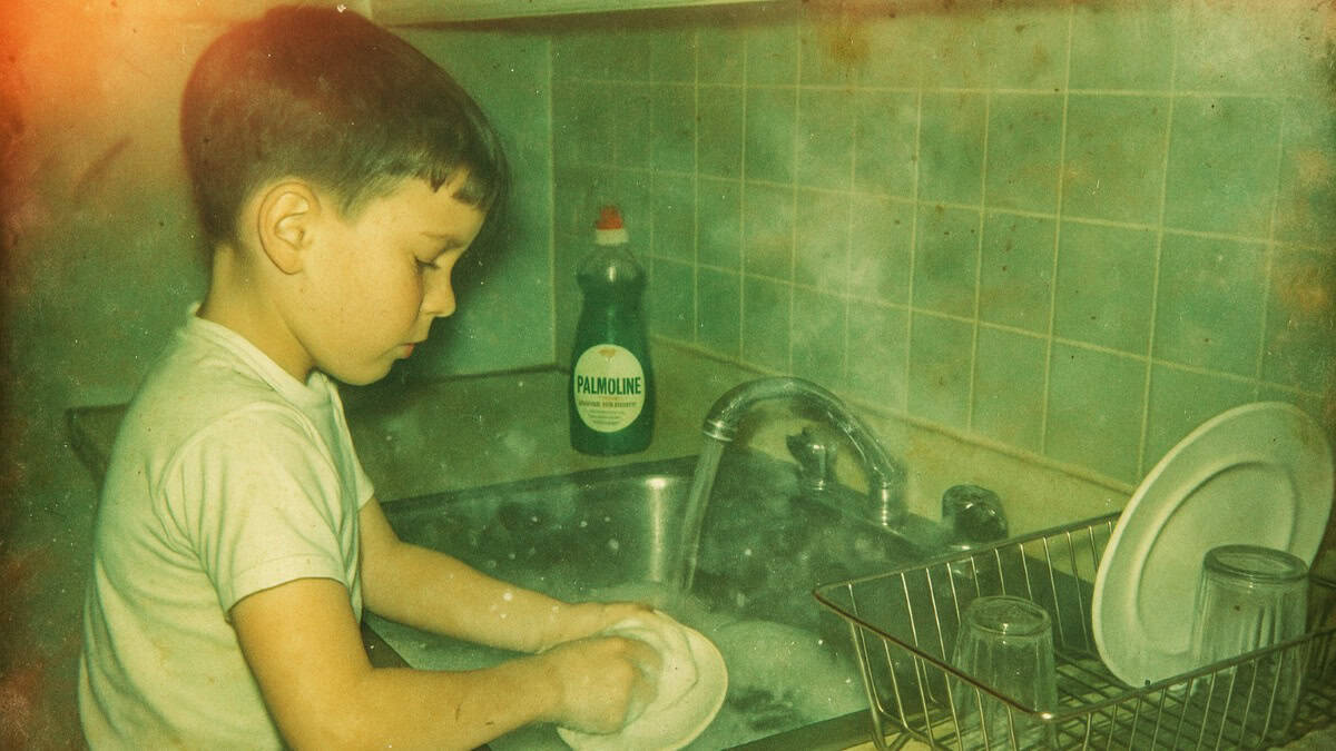 Growing Up in a Big Family: What Nobody Else Gets 10 A child washing dishes by hand, illustrating a chore that builds character.