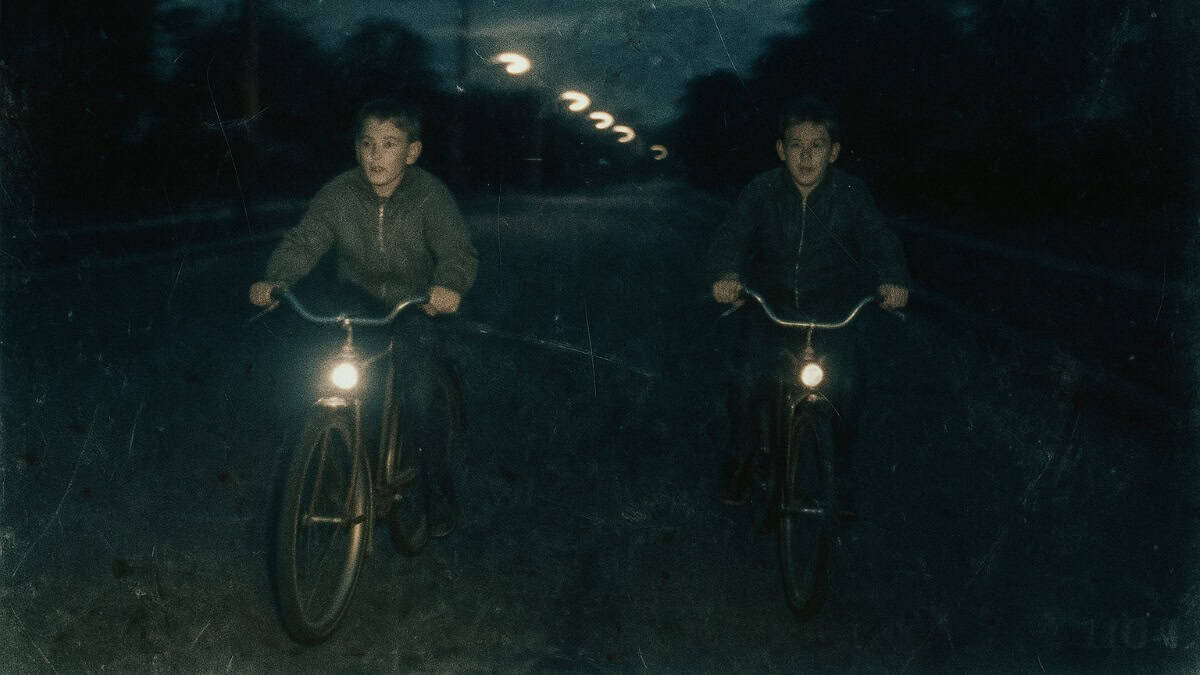 Old-School Discipline Methods That Actually Worked 3 A child riding a bike at night, reflecting risky childhood biking adventures.