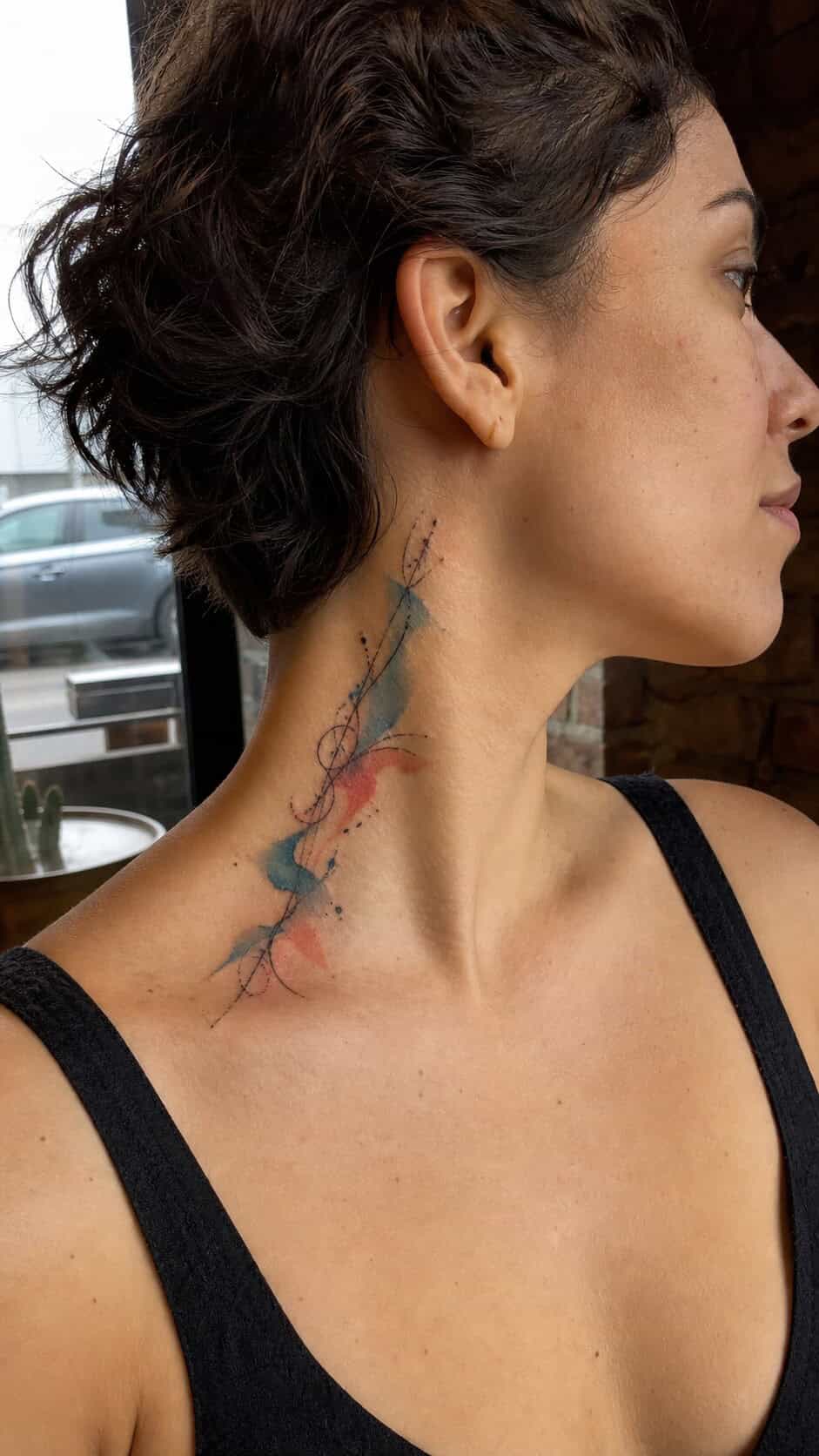 From Delicate to Daring: 28 Neck Tattoo Ideas for Every Woman 10 Abstract Watercolor Splash neck tattoo idea, example 2