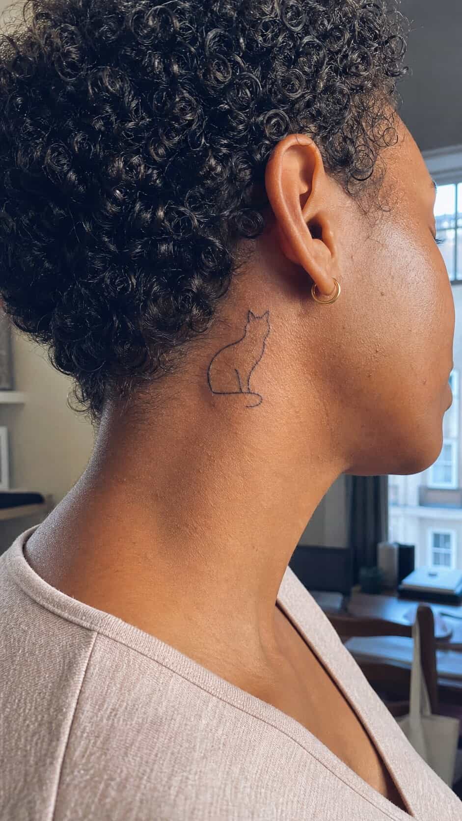From Delicate to Daring: 28 Neck Tattoo Ideas for Every Woman 17 Feline Silhouette neck tattoo idea, example 2