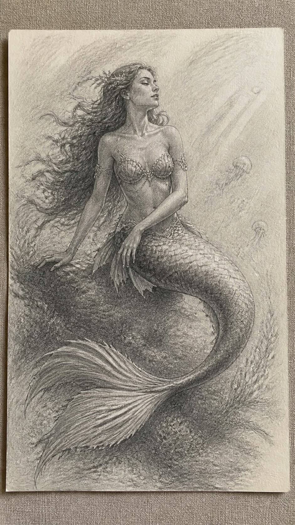 20 Girl Drawing Concepts to Elevate Your Art Game 12 Hand-drawn mystical mermaid in graphite drawing on textured paper, shown in a close overhead crop — study 2
