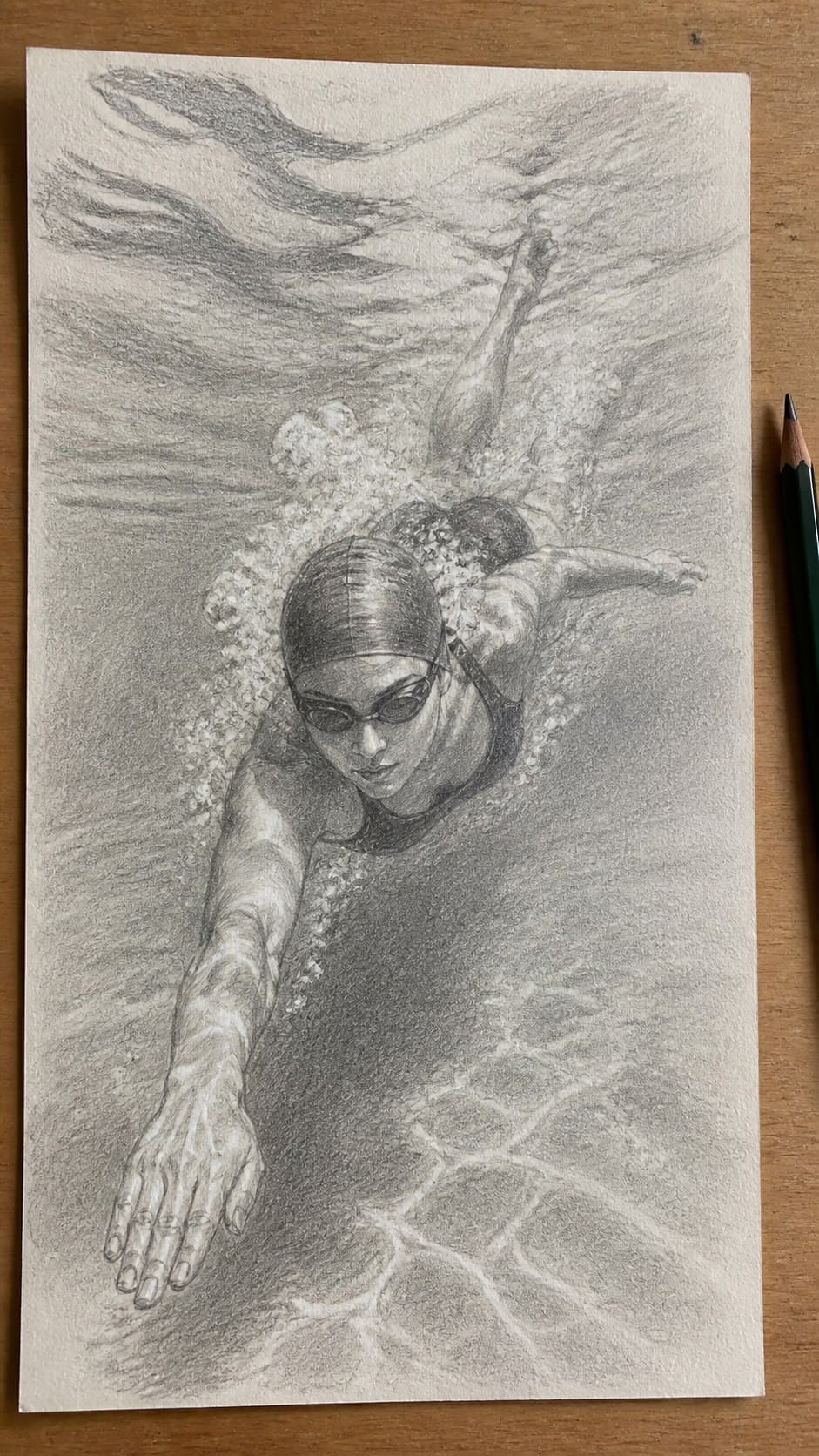 Hand-drawn graceful swimming motion in graphite drawing on textured paper, shown in a slightly off-center overhead composition, like — study 1