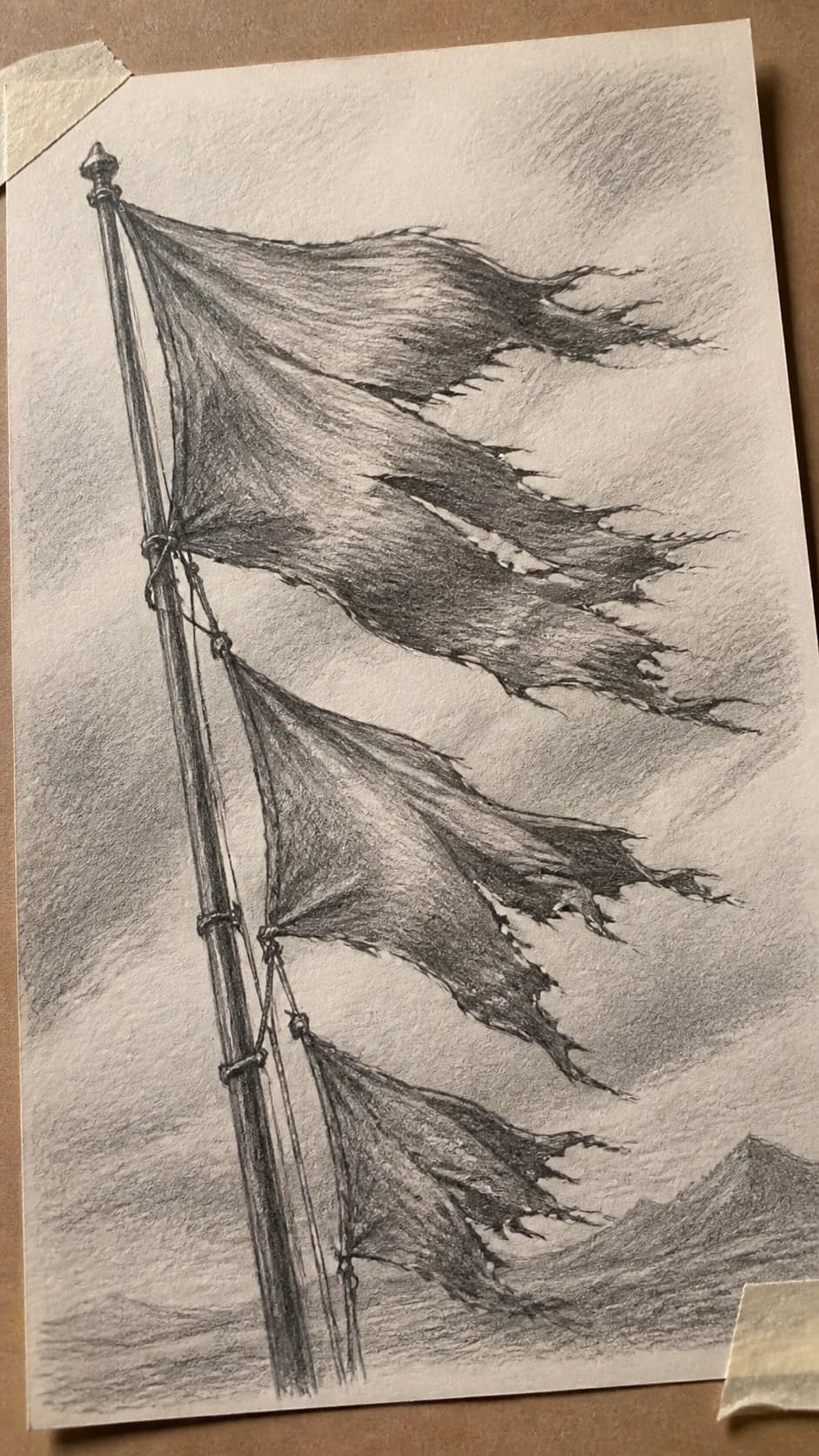 30 Grunge Drawing Ideas for Real Depth and Texture 14 Hand-drawn tattered flags in graphite drawing on textured paper, shown in a gentle oblique desk view that shows paper tooth and — study 1