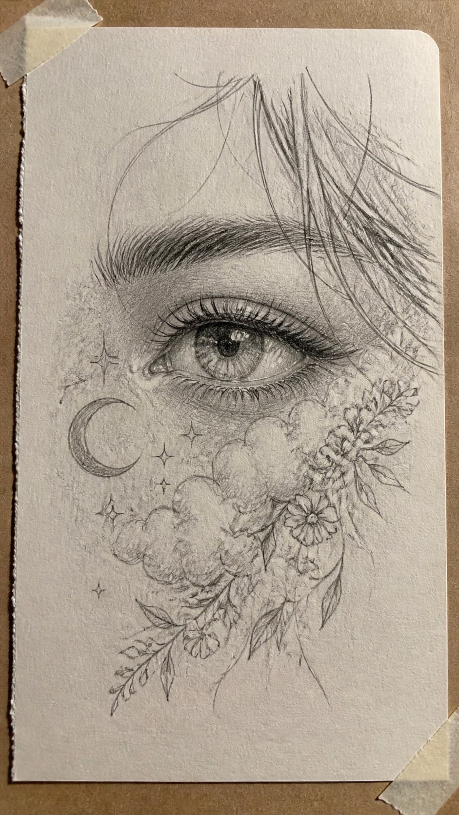 Hand-drawn dreamy eyes in graphite drawing on textured paper, shown in a close overhead crop — study 1