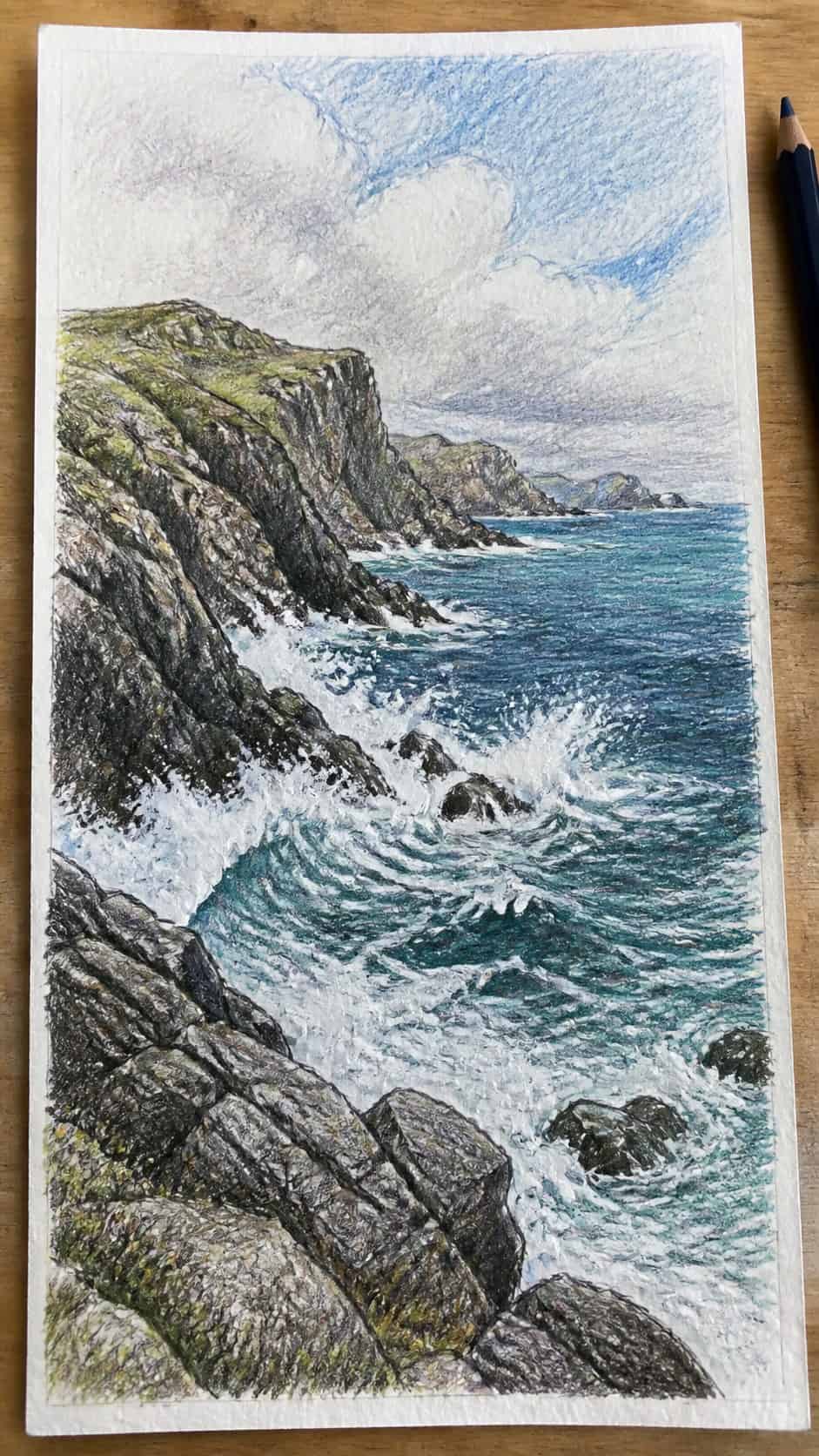 Hand-drawn rocky coastal cliffs in colored-pencil and gouache drawing on textured paper, shown in a straight overhead view — study 1