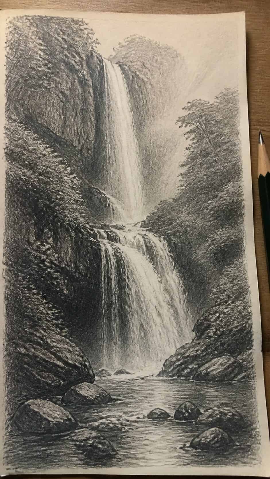 17 Nature Drawing Concepts to Inspire Your Next Sketch 12 Hand-drawn enchanting waterfall in graphite drawing on textured paper, shown in a close overhead crop — study 2