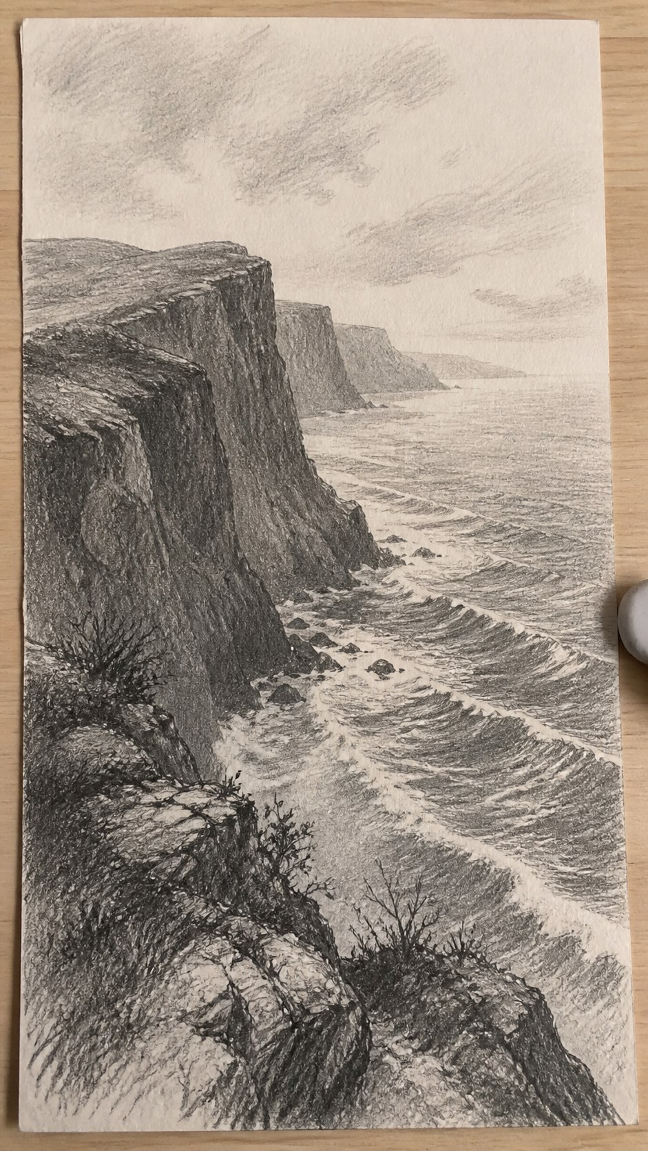 17 Nature Drawing Concepts to Inspire Your Next Sketch 14 Hand-drawn coastal cliffside in graphite drawing on textured paper, shown in a close overhead crop — study 1
