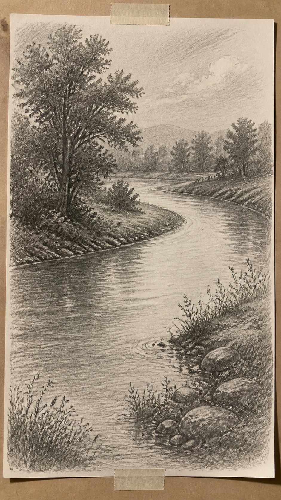 17 Nature Drawing Concepts to Inspire Your Next Sketch 17 Hand-drawn gentle river bend in graphite drawing on textured paper, shown in a straight overhead view — study 1