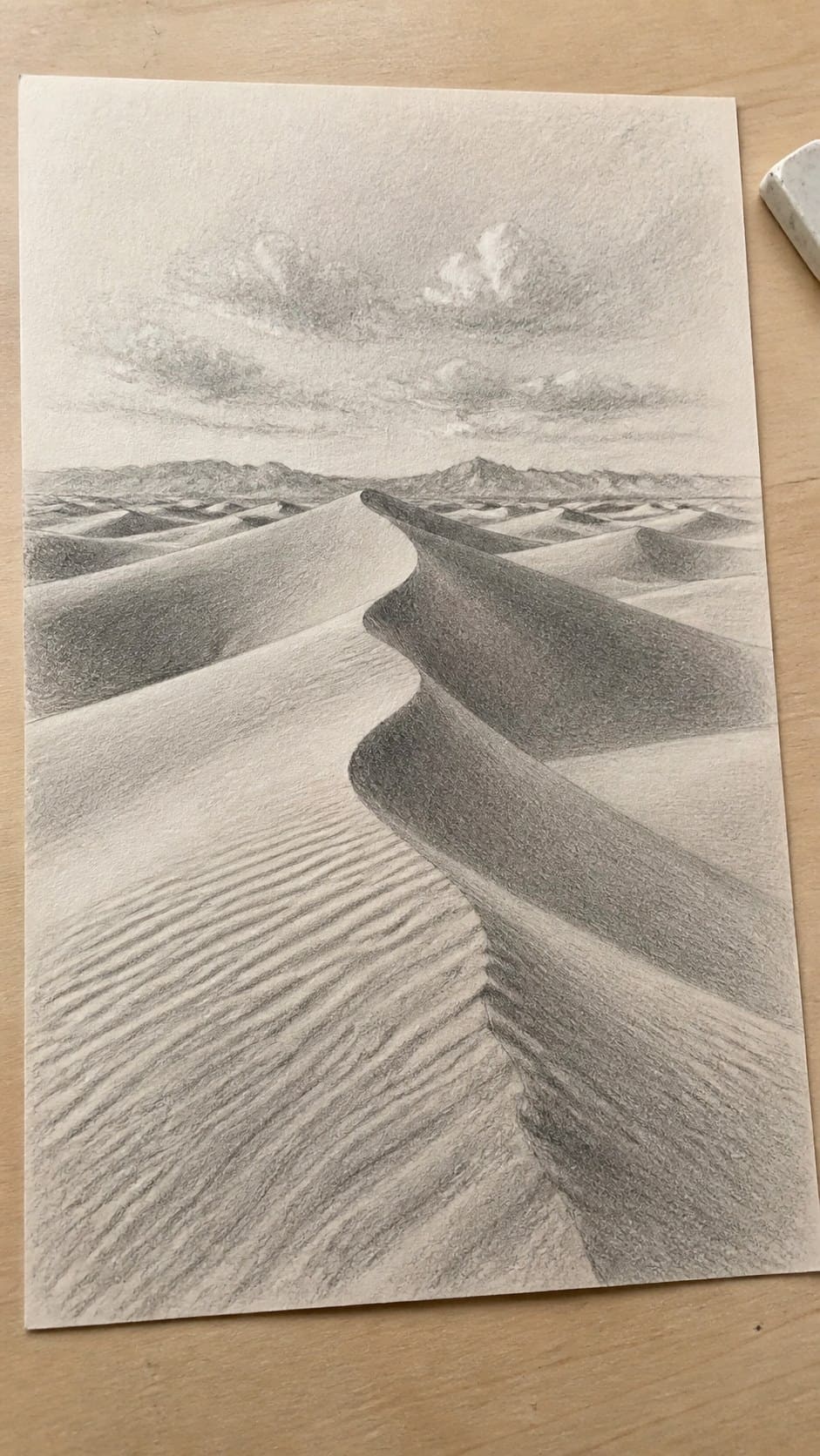 17 Nature Drawing Concepts to Inspire Your Next Sketch 20 Hand-drawn desert dunes in graphite drawing on textured paper, shown in a slightly off-center overhead composition, like an artist — study 2
