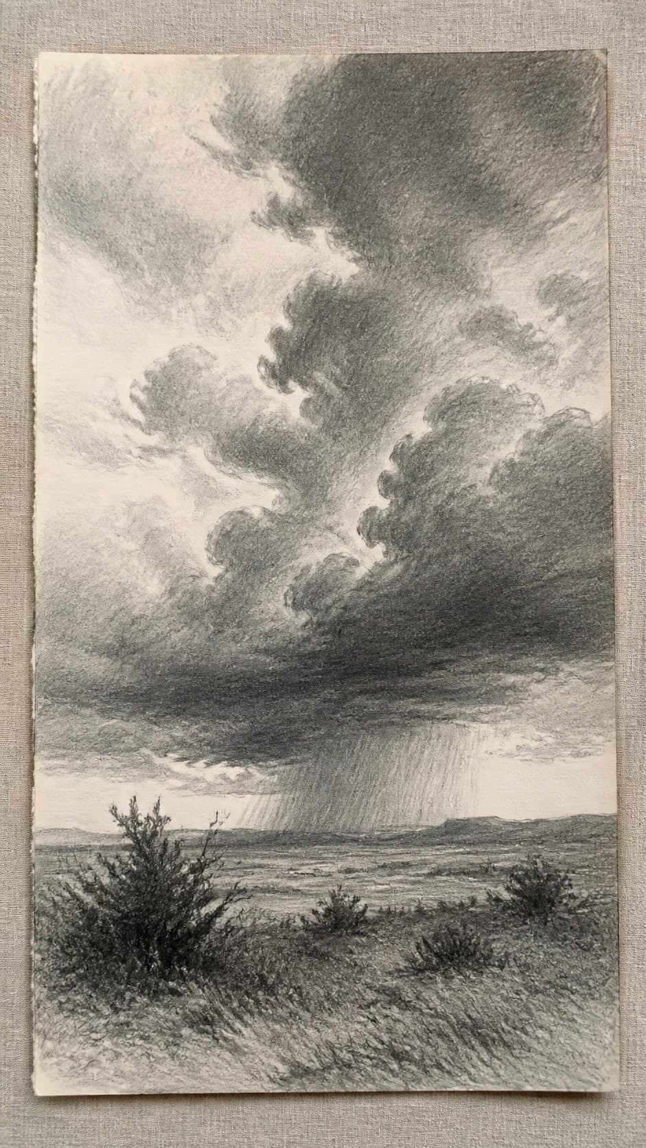 17 Nature Drawing Concepts to Inspire Your Next Sketch 26 Hand-drawn stormy skies in graphite drawing on textured paper, shown in a close overhead crop — study 1