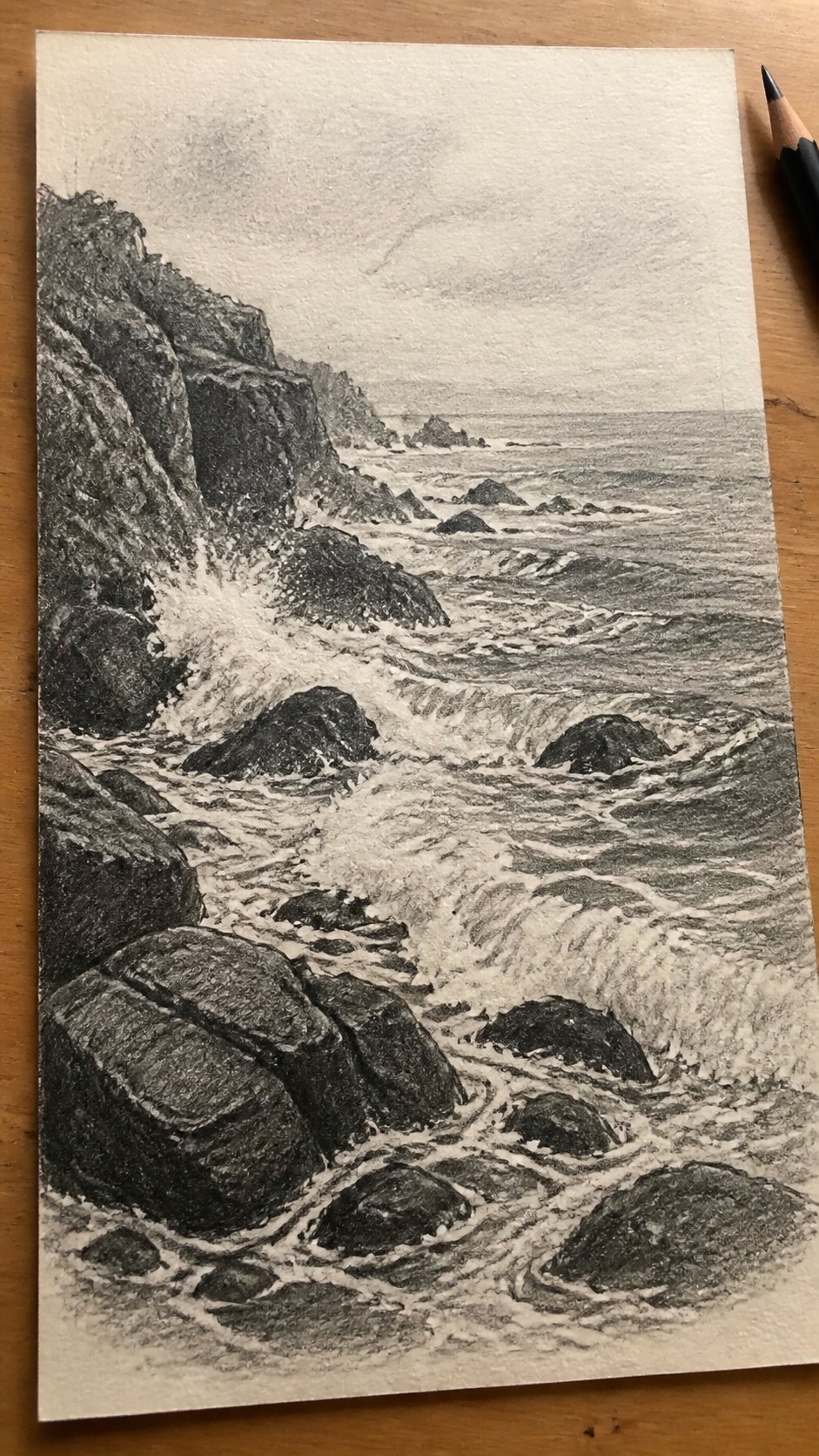 17 Nature Drawing Concepts to Inspire Your Next Sketch 41 Hand-drawn rocky shoreline in graphite drawing on textured paper, shown in a slightly off-center overhead composition, like an artist — study 1