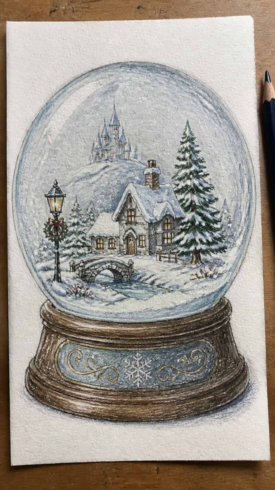 Hand-drawn enchanted snow globe scene in colored-pencil and gouache drawing on textured paper, shown in a straight overhead view — study 1