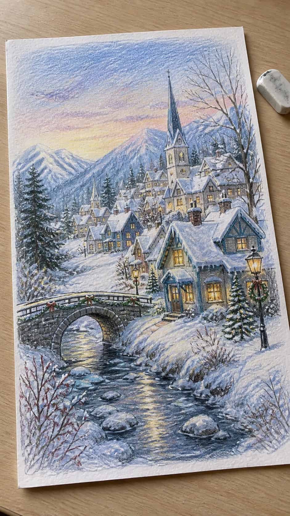 Hand-drawn frosty winter village in colored-pencil and gouache drawing on textured paper, shown in a gentle oblique desk view that — study 2